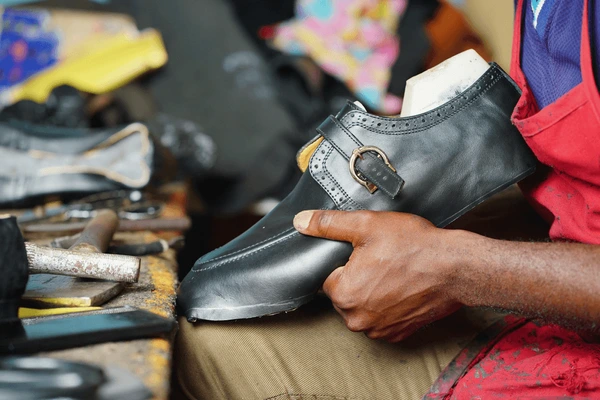 Artisan crafting a custom shoe