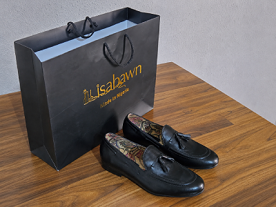 Custom handmade leather shoes packaged in Ilisabawn branded shopping bag, ready for delivery